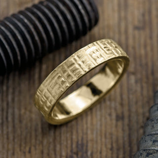 14k yellow gold men's wedding band with 6mm wide and textured matte finish, showcasing its elegant craftsmanship