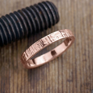 Radiant 4mm 14k Rose Gold Mens Wedding Band with a unique textured polished finish, detailed view