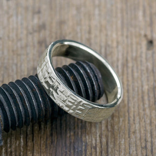 Detailed view of a 6mm Men's Wedding Band in 14k White Gold with polished texture, macro shot