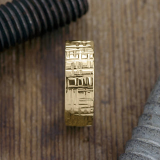 Close-up view of the texture detail on the 14k Yellow Gold Men's Wedding Ring