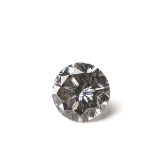 Close-up of a 1.38 Carat Salt and Pepper Brilliant Cut Round Diamond showcasing unique speckles and natural inclusions, handcrafted with eco-friendly values.