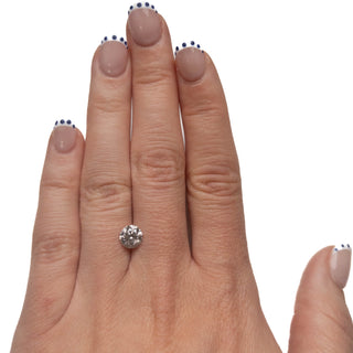 Hand wearing a 1.35 Carat Salt and Pepper Brilliant Cut Round Diamond, showcasing a unique eco-friendly, conflict-free diamond with natural speckles, handcrafted in Washington state.