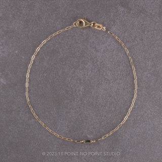Angled view of the exquisite .04ct Salt and Pepper Baguette Diamond Bracelet made of 14k Yellow Gold