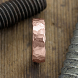 Close-up view of the intricate hammering and matte finish on a 14k Rose Gold Mens Wedding Band