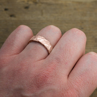14k Rose Gold Mens Wedding Band with a unique 6mm width, displayed in a refined, hammered matte style