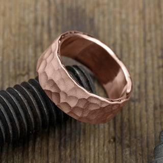 Distinctive 14K Rose Gold 8mm Mens Wedding Band with a Hammered Matte design, focusing on the unique texture