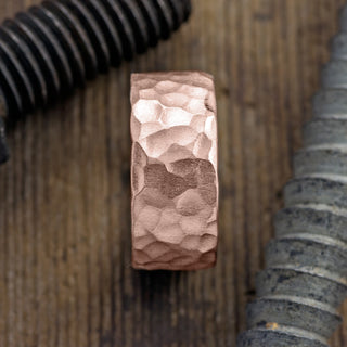 Close-up shot of the hammered matte texture on the 10mm 14k Rose Gold Mens Wedding Band