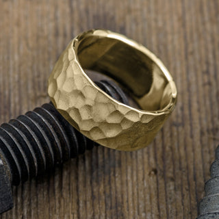 Close-up view of 10mm 14k Yellow Gold Men's Wedding Ring with Hammered Matte finish
