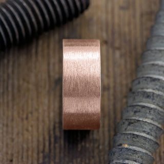 Profile view of a 10mm Men's Ring in 14K Rose Gold with Brushed Matte Design