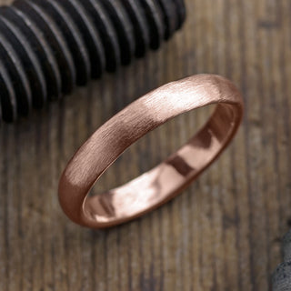 Half round 4mm men's wedding band in 14k rose gold with matte finish, viewed from top