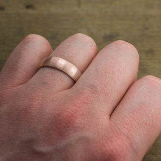 Detail view of a 6mm Mens Wedding Band in 14K Rose Gold with a half round matte finish