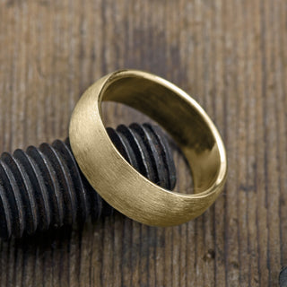 8mm Yellow Gold Mens Wedding Band with a matte finish, shown worn on a finger