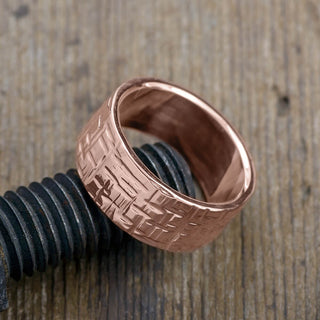 Luxurious 10mm 14k Rose Gold Men's Wedding Band with an intricate Textured Polished design, depicted from a side angle