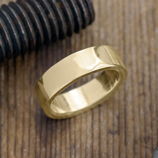 Close-up view of 6mm 14k Yellow Gold Mens Wedding Band showing polished finish