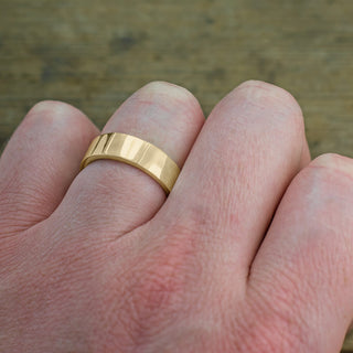 Detail view of the 14k Yellow Gold Mens Wedding Band, emphasizing the 6mm width and polished texture