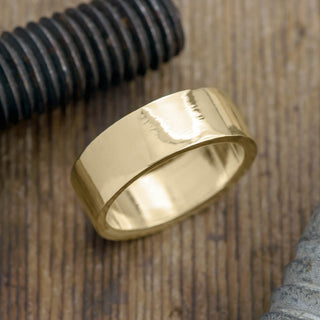 Beautiful 8mm 14k Yellow Gold Mens Wedding Band with a high polish finish displayed from a front view