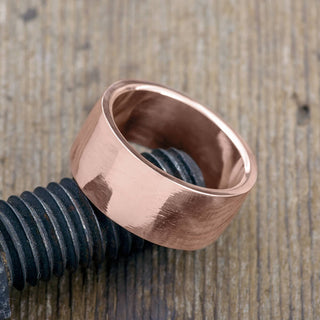 Detail of the smooth polished finish on a 10mm 14k rose gold mens wedding ring