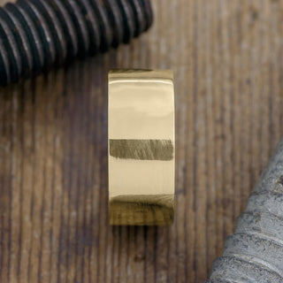 Angled view of a 10mm 14k Yellow Gold High Polish Men's Wedding Band