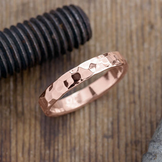14k Rose Gold Men's Wedding Band with 4mm width, in a polished hammered finish, displayed against a white background