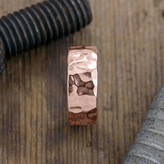 Side view of the 8mm 14k Rose Gold Hammered Mens Wedding Band with noticeable high polished shine