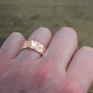 Close-up image of the 8mm 14k Rose Gold Hammered Mens Wedding Band with a high polished finish