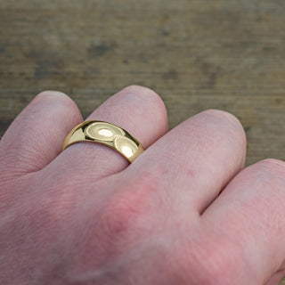 High polished 14k yellow gold men's wedding band in 8mm highlighting its half round shape