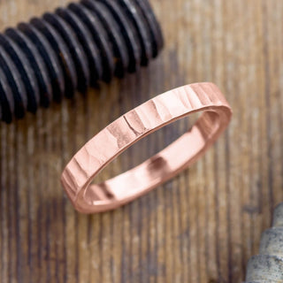 Stunning 4mm 14k Rose Gold Mens Wedding Band with wood grain matte finish, showcased at an angle