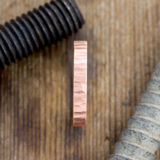 Close-up of the wood grain details on the Matte 4mm 14k Rose Gold Mens Wedding Band