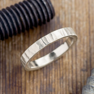 4mm wide 14k white gold men's wedding band with intricate wood grain design in matte finish viewed from a top angle