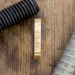 Close-up of the 4mm 14k Yellow Gold Men's Wedding Band highlighting the unique wood grain matte design