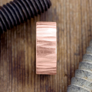 Detailed side image of a 14k Rose Gold Men's Wedding Band with 10mm width and unique wood grain matte finish.