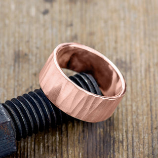Aesthetic image of 10mm Men's Wedding Band crafted in 14k rose gold with an attractive wood grain matte design.