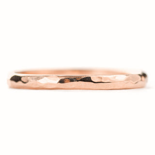 Detail of 2mm Wide x 1.7mm Thick 14k Rose Gold Wedding Band with a hammered texture and high-polish finish