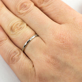 14k white gold wedding band with a high polish and hammered details, beautifully reflecting light