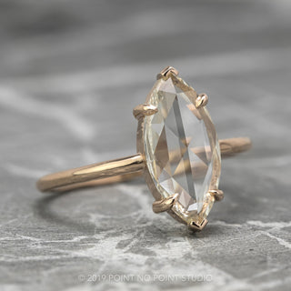 Luxurious Jane setting engagement ring with 1.35 carat marquise diamond on 14K rose gold band, angled view