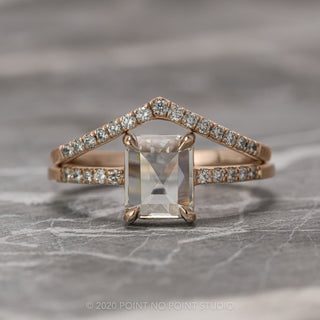 1.55 carat clear emerald diamond engagement ring on a twisted 14K rose gold Jules setting isolated on white background