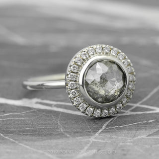 14k white gold ring with a 2.04 carat round salt and pepper diamond, showcasing the bezel halo setting's allure from a side perspective.