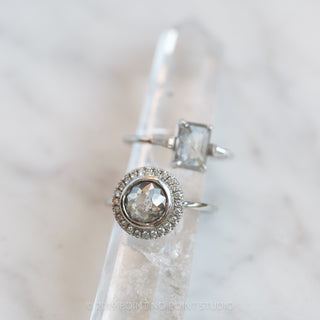 Close-up of 2.04 carat salt and pepper diamond engagement ring with luxurious bezel halo design in 14k white gold.
