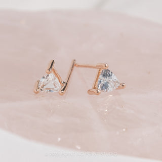 Close-up of 14k Rose Gold Sapphire Triangle Studs, signifying luxury and elegance